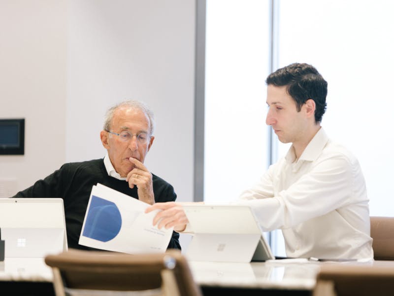 Baron Capital CEO Ron Baron and Research Analyst Adam Lieb reviewing research.