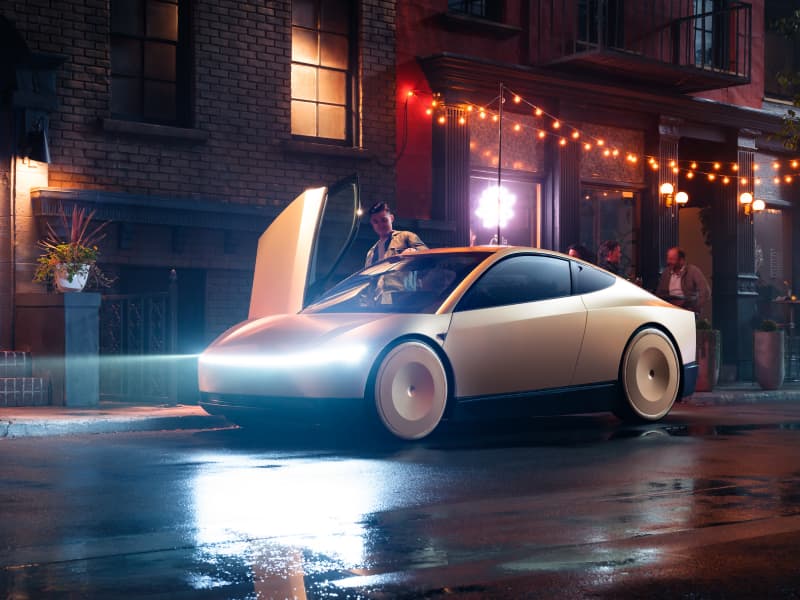 A Tesla Cybercab autonomous vehicle picking up a passenger